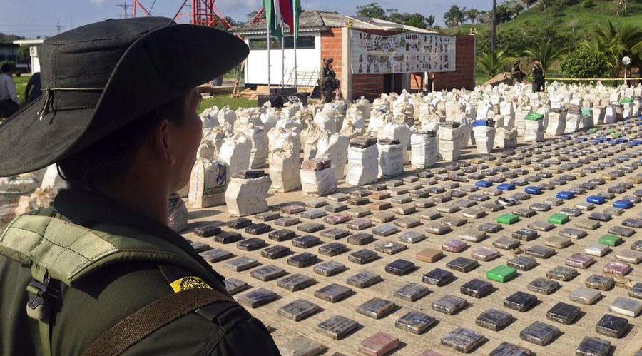 A Colombian police officer standing guard over eight tons of seized cocaine in Turbo, Antioquia department, on May 15, 2016. © Colombian police